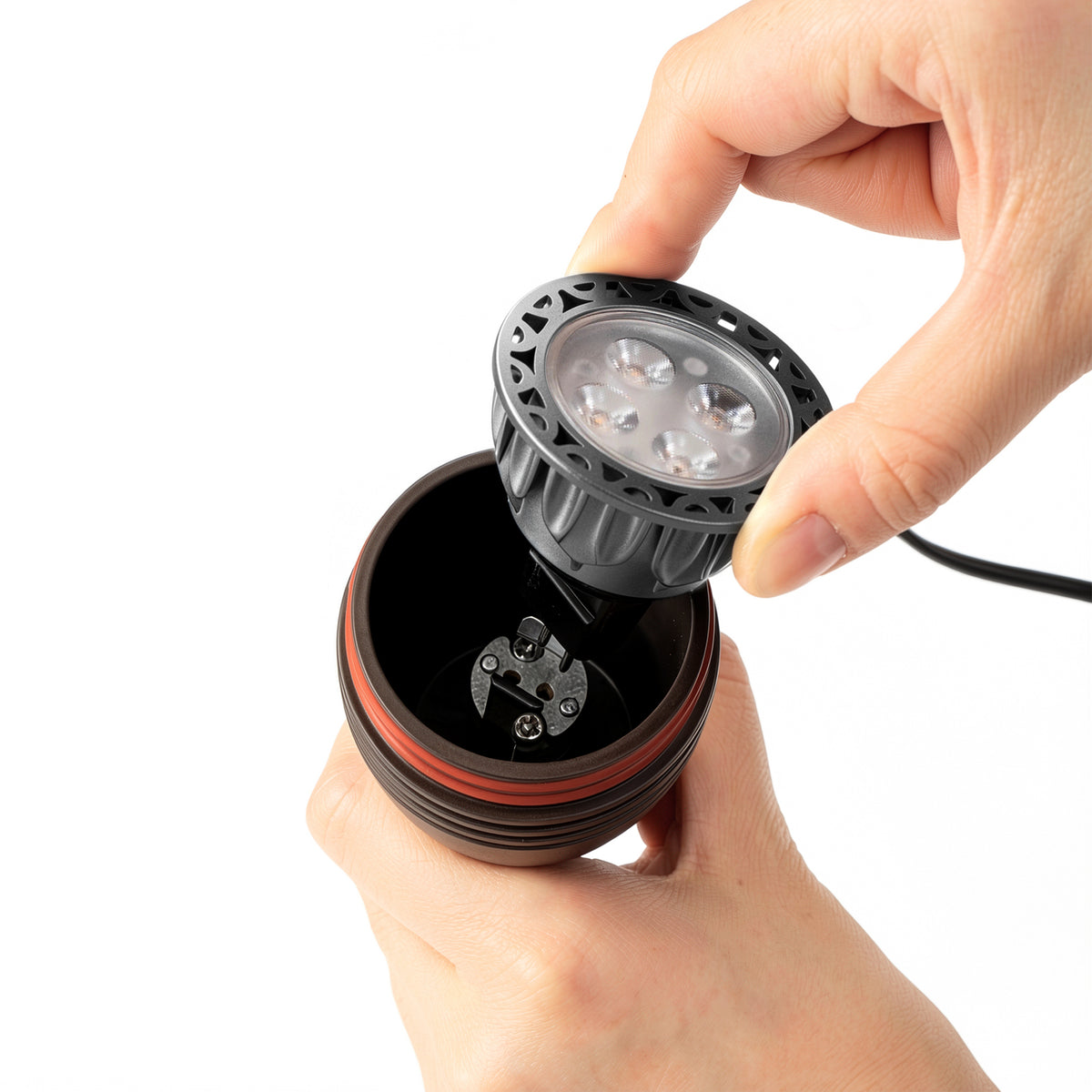 HIBOITEC Spotlight in oil rubbed bronze — MR16 bulb being removed from the socket