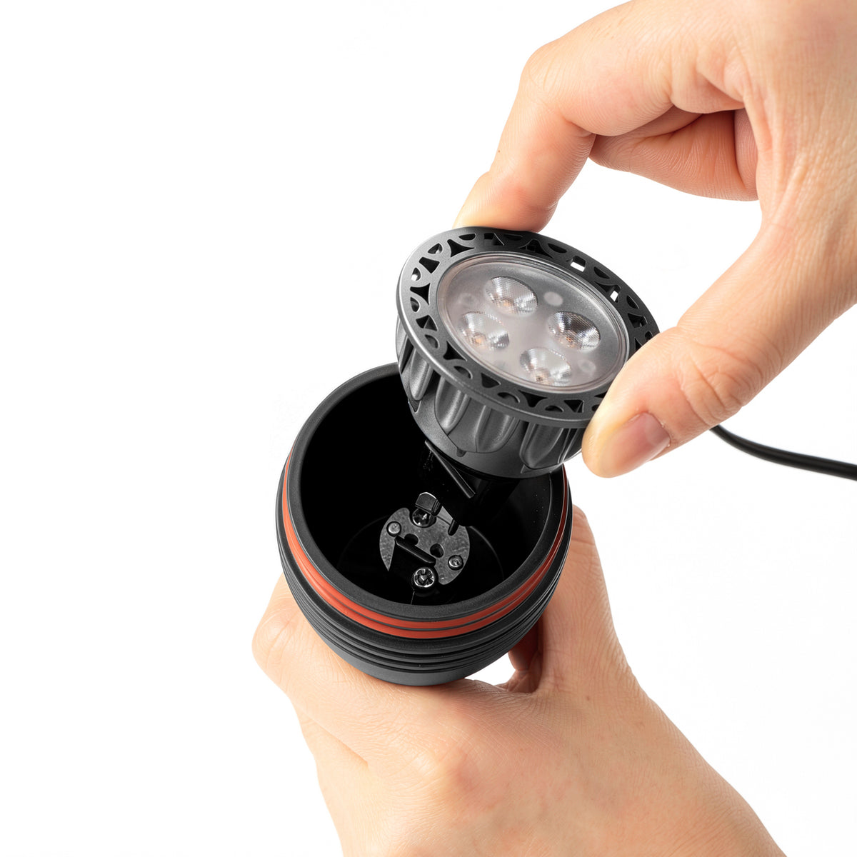 HIBOITEC Spotlight in sand black — MR16 bulb being removed from the socket